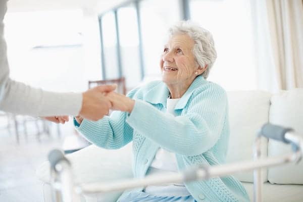 Healthcare worker helping an elderly patient in a assisted living facility.